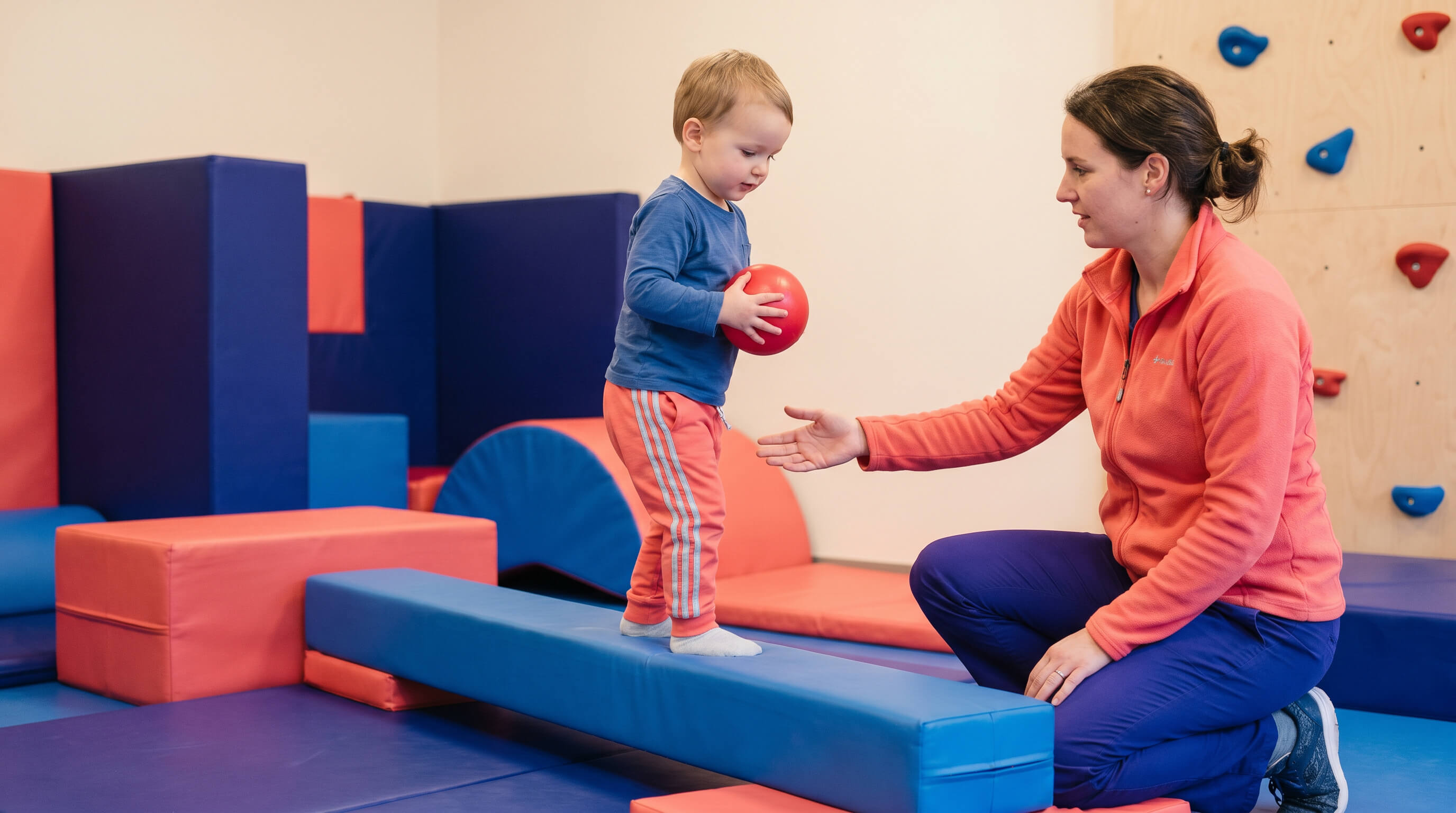 Kind macht Koordinationsübung mit Ball 